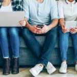 Group of young people with smart phones, digital tablets and laptop